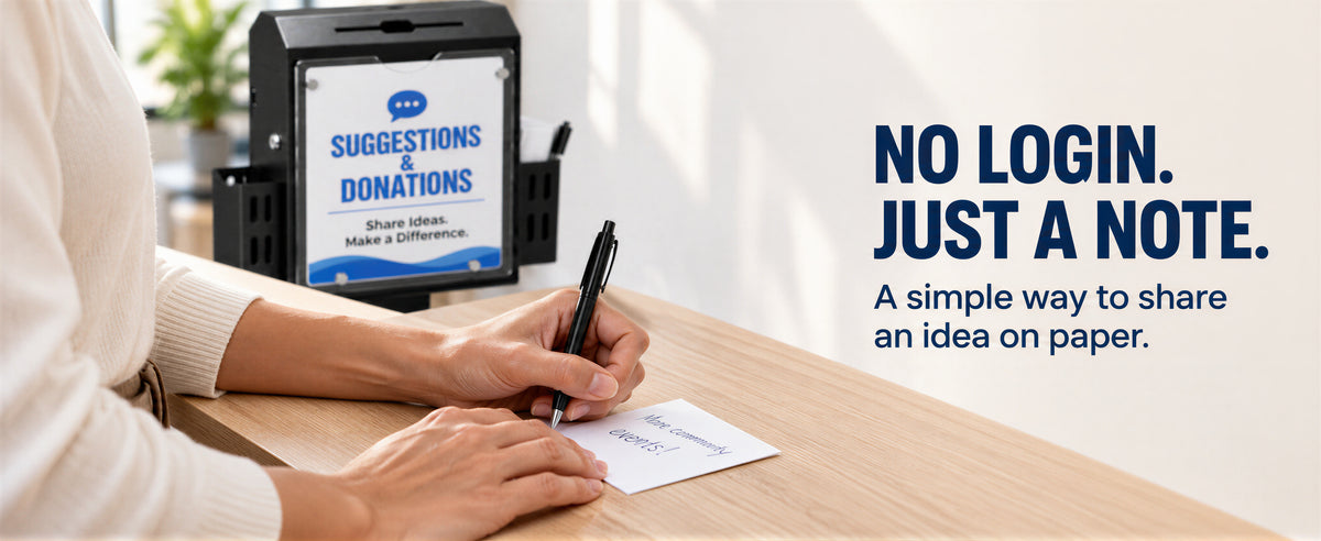 A person writes a paper feedback note beside the suggestion box.